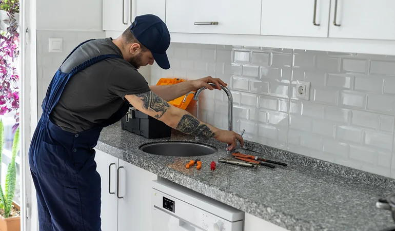 Sacramento plumbing expert repairing bathroom pipe
